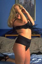 Good looking big blonde girl running her finger through her hair.