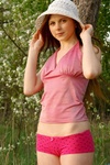 Cute porn teen in cap and sexy pink overall teasing nice on the forest