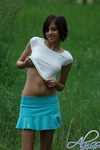Alyssa strips off her clothes in a wide open field