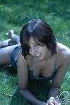 Alyssa wears just a gamouflage shirt in the grass