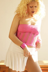 Sexy teen in fishnets and a pink dress