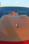 Dirty teen spreads pussy on the hood of a car