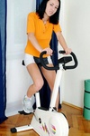 Lauren rides her stationary bike but her giant tits keep bouncing so she gets off and strips
