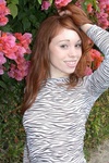Redhead teen shows off her furry pussy on the beach